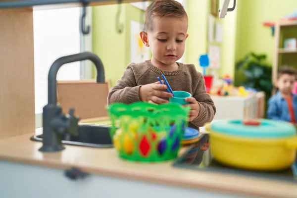 Adorable Hispanic Boy Playing Play Kitchen Standing Kindergarten — Stockfoto