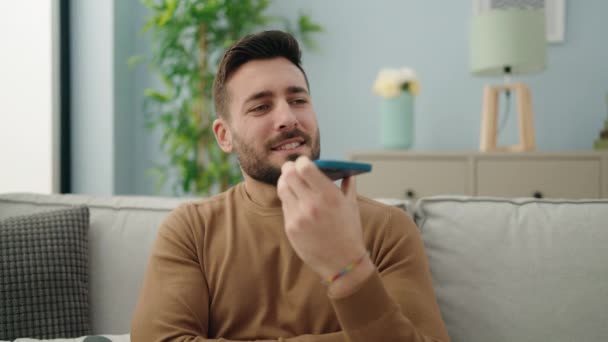 Young Hispanic Man Talking Smartphone Sitting Sofa Home — Stockvideo