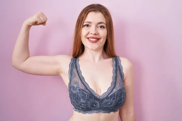 Redhead Woman Wearing Lingerie Pink Background Strong Person Showing Arm — Stock fotografie