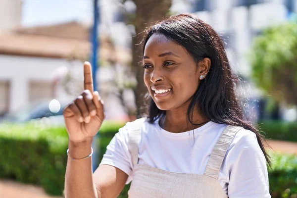 Young african american woman standing with idea expression at park