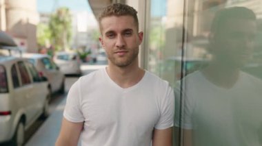 Young caucasian man smiling confident standing at street