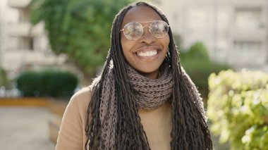 African woman smiling confident at park