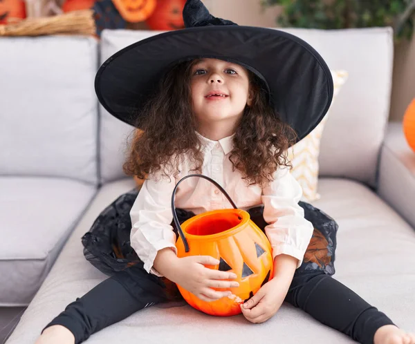 Adorable Hispanic Girl Wearing Halloween Costume Holding Pumpkin Basket Home — Stok fotoğraf