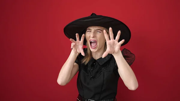Young Blonde Woman Wearing Witch Costume Doing Scare Gesture Isolated —  Fotos de Stock