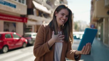 Young caucasian woman smiling confident having video call at street