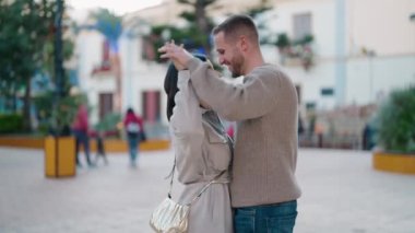 Young couple smiling confident dancing at park