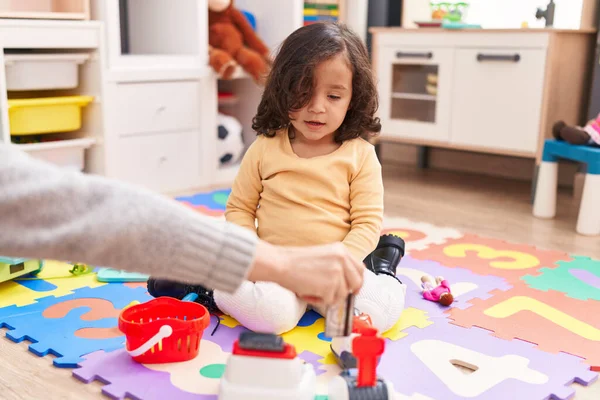 Adorable Hispanic Toddler Playing Supermarket Toy Sitting Floor Kindergarten — Stockfoto
