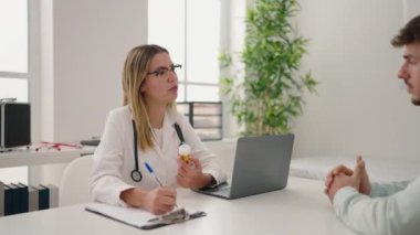 Young couple doctor and patient prescribe pills at clinic