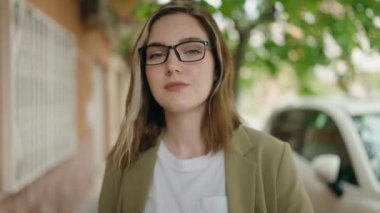 Young woman business worker pointing with finger to canada passport at street