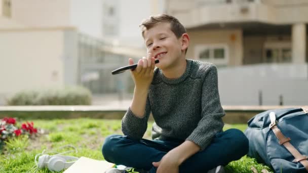 Blond Child Talking Smartphone Sitting Grass Park — Wideo stockowe
