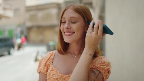 Young Redhead Woman Smiling Confident Listening Audio Message Smartphone Street — 비디오
