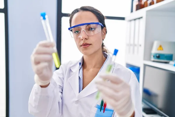 Young Hispanic Woman Wearing Scientist Uniform Holding Test Tubes Laboratory — Fotografia de Stock