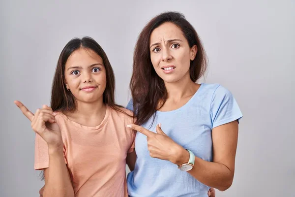Young Mother Daughter Standing White Background Pointing Aside Worried Nervous —  Fotos de Stock