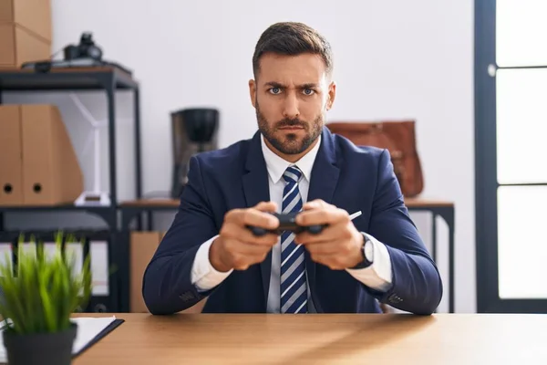 Handsome Hispanic Man Playing Video Games Office Skeptic Nervous Frowning — Stock Photo, Image