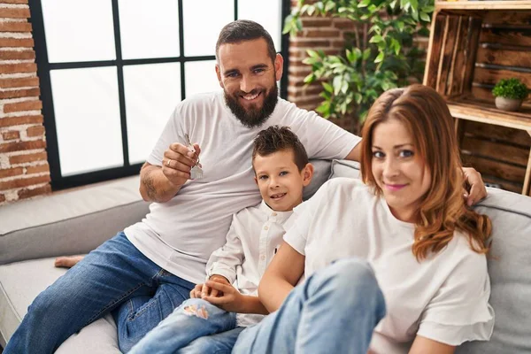 Family Holding Key New House Hugging Each Other Sitting Sofa — Stockfoto