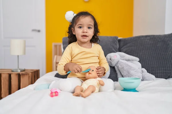 Adorable Hispanic Toddler Playing Baby Doll Sitting Bed Bedroom — Stok fotoğraf