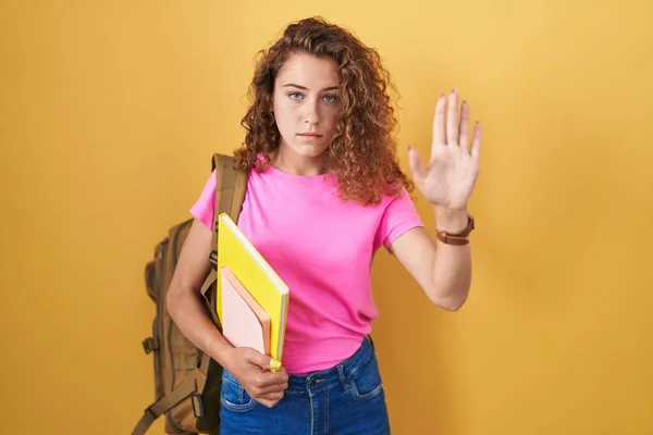 Young Caucasian Woman Wearing Student Backpack Holding Books Doing Stop — Stock fotografie