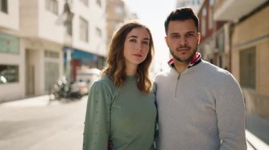 Young couple kissing and hugging each other standing at street