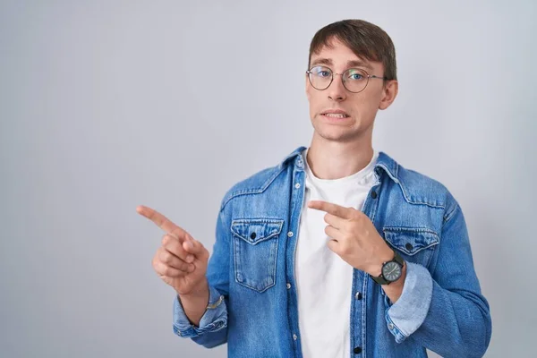 Caucasian Blond Man Standing Wearing Glasses Pointing Aside Worried Nervous — Stockfoto