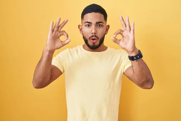 Young Hispanic Man Standing Yellow Background Looking Surprised Shocked Doing — Stockfoto