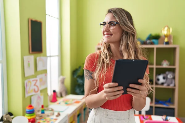 Young Blonde Woman Teacher Using Touchpad Standing Kindergarten — Stock Photo, Image