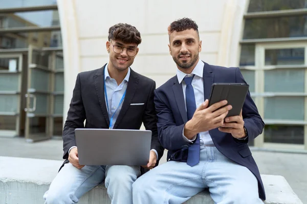 Two Hispanic Men Business Workers Using Touchpad Laptop Working Street —  Fotos de Stock