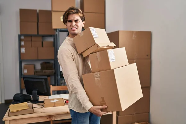 Young Man Working Small Business Ecommerce Holding Packages Clueless Confused — Stockfoto