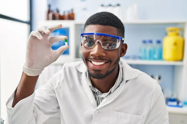 Young African American Man Wearing Scientist Uniform Holding Pill Laboratory — Stockfoto