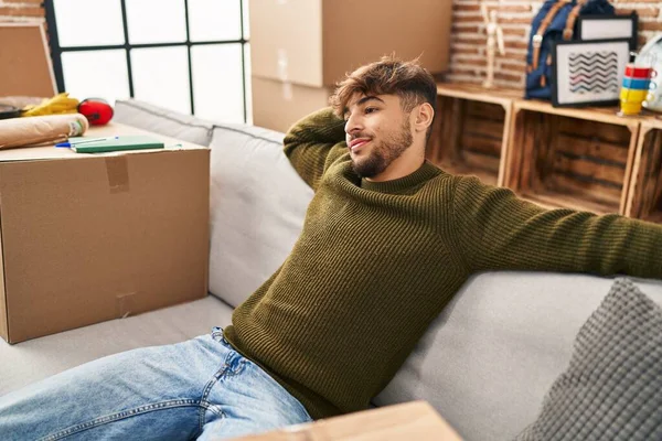 Young Arab Man Smiling Confident Relaxed Sofa New Home — Foto Stock
