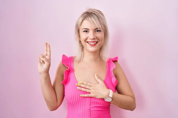 Pembe Arka Planda Duran Beyaz Bir Kadın Gülümsüyor Elleri Göğsünde — Stok fotoğraf