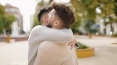 Young couple smiling confident hugging each other and kissing at park
