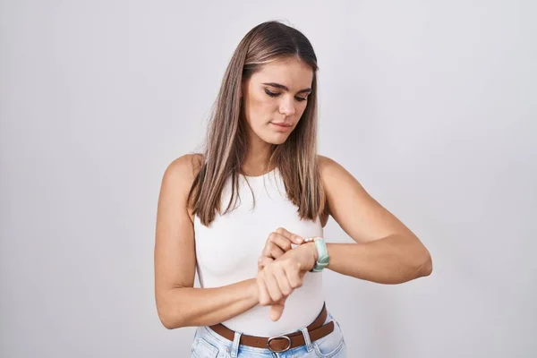 Hispanic Young Woman Standing White Background Checking Time Wrist Watch —  Fotos de Stock