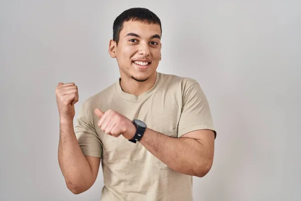 Młody Arabski Mężczyzna Noszący Luźną Koszulę Wskazującą Plecy Rękami Kciukami — Zdjęcie stockowe