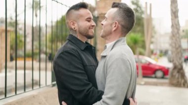 Young couple smiling confident hugging each other standing at street