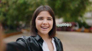 Young hispanic woman smiling confident having video call at park