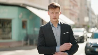 Young caucasian man smiling confident standing with arms crossed gesture at street