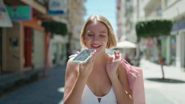 Young Blonde Woman Talking Smartphone Walking Street — Video