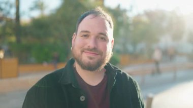 Young plus size man smiling confident standing at park