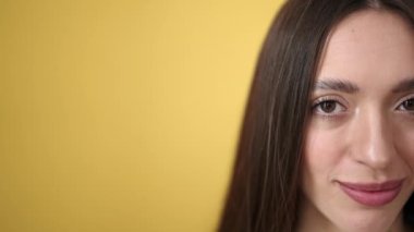 Young beautiful hispanic woman smiling confident standing over isolated yellow background