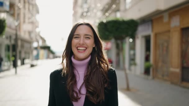 年轻的惊慌失措的女人带着自信的笑容走在街上 — 图库视频影像