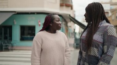 Two african american women smiling confident making selfie by the smartphone at street