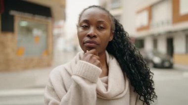 African american woman standing with doubt expression at street