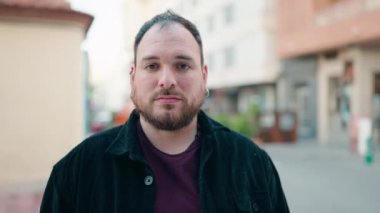 Young plus size man smiling confident standing with arms crossed gesture at street