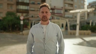 Young caucasian man smiling confident standing at street