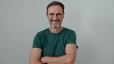 Middle age man standing with arms crossed gesture over isolated white background