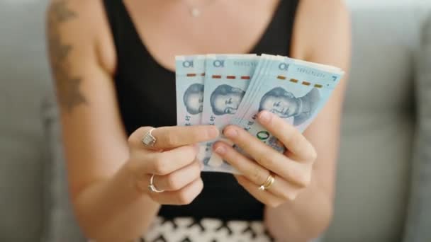 Young Woman Counting China Yuan Banknotes Home — Vídeo de stock