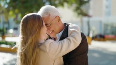 Middle age couple couple smiling confident dancing at park