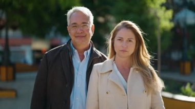 Middle age couple couple smiling confident standing together at park