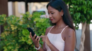 Young beautiful woman smiling confident having video call at street