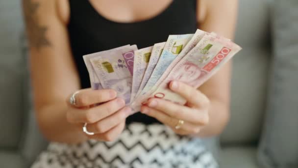 Young Woman Counting Sweden Kronor Banknotes Home — Stok video